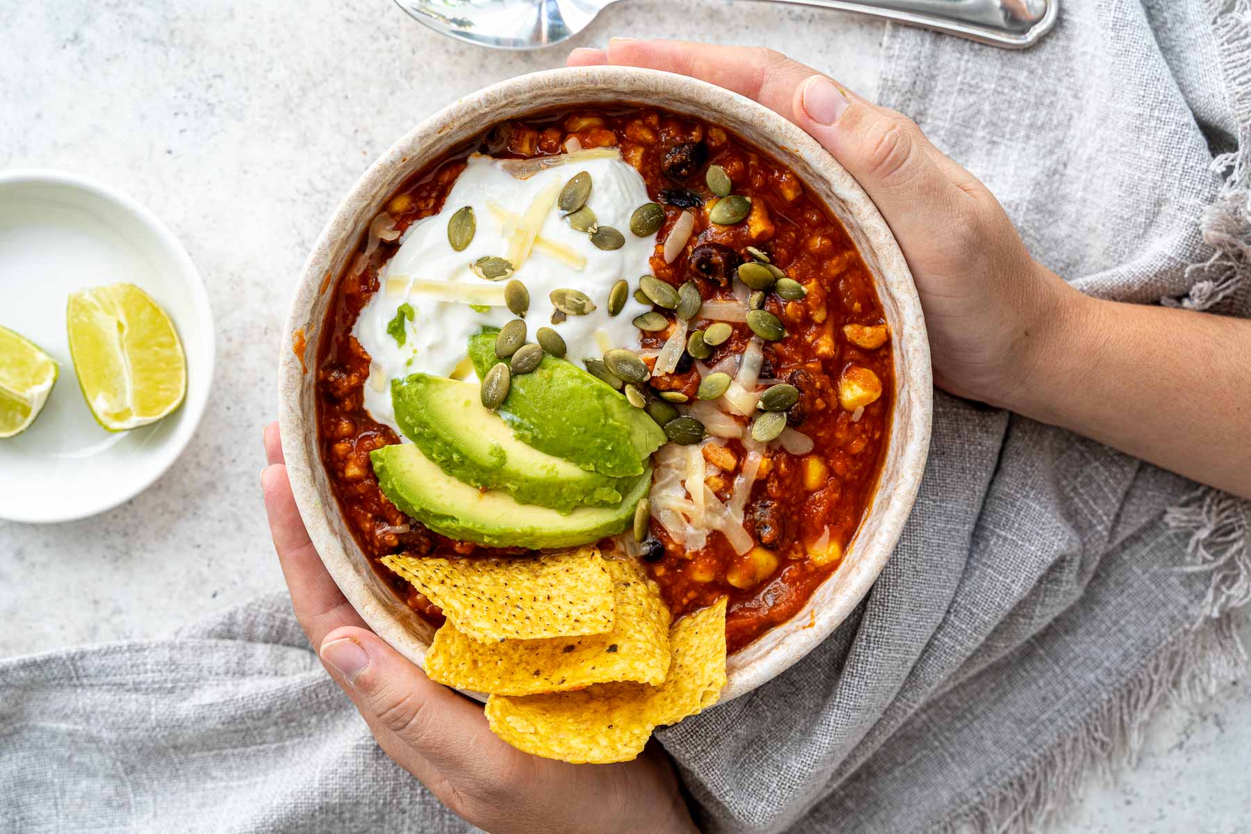 Pumpkin chili in bowl with toppings