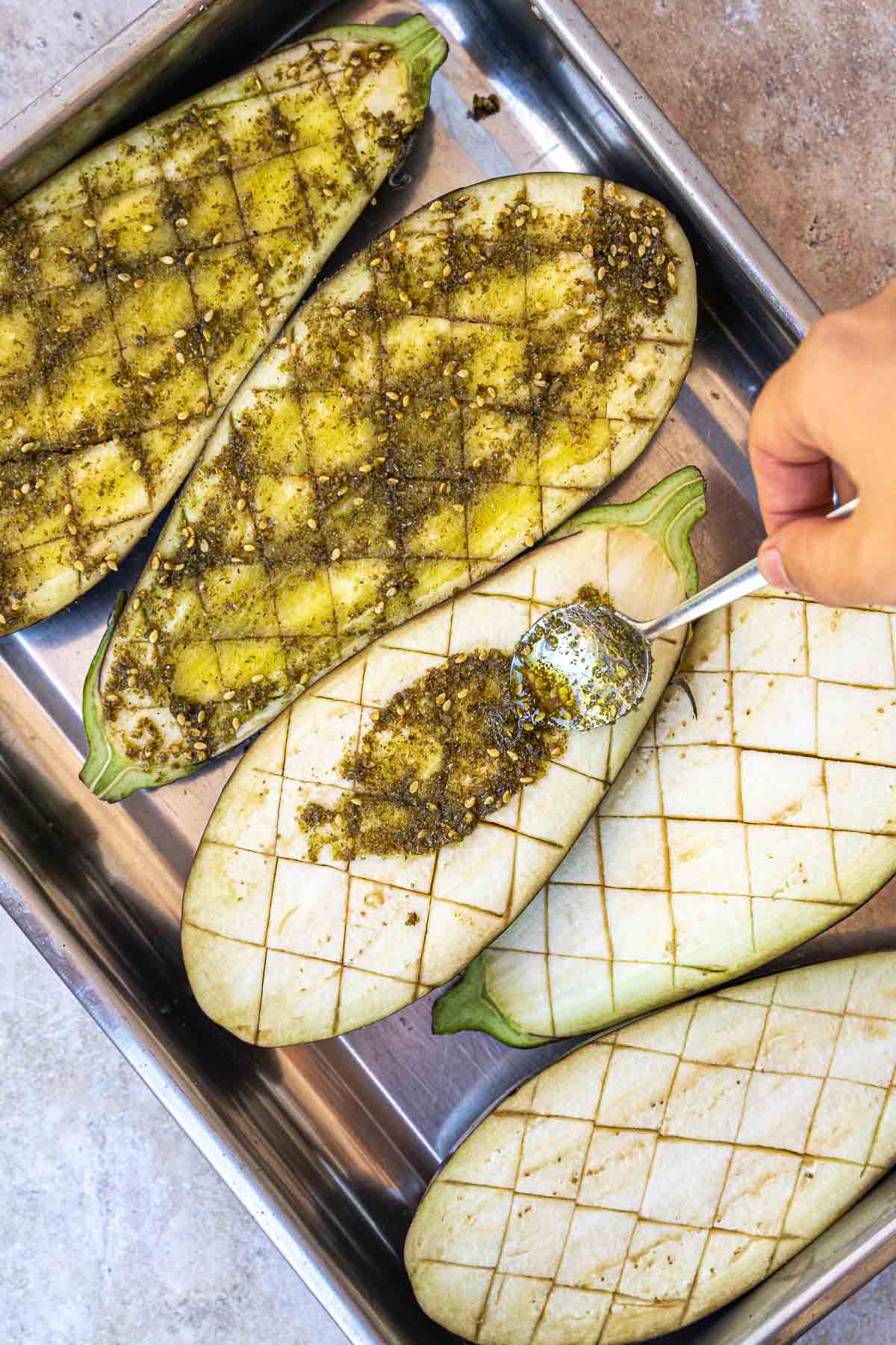 adding the marinade to the eggplants