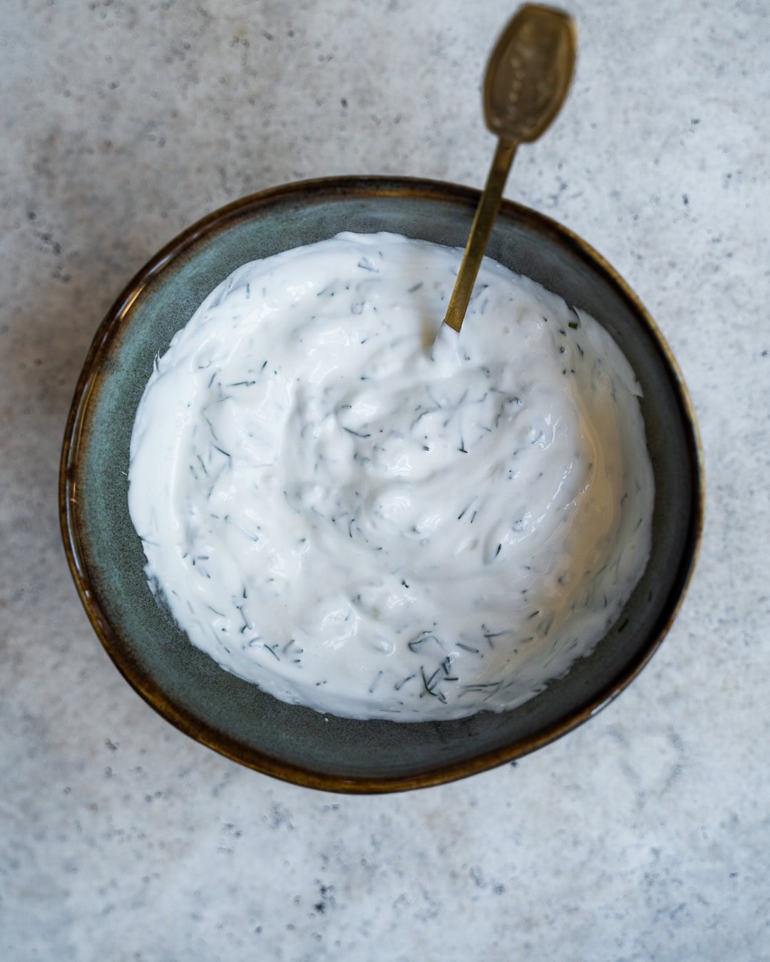 Greek Yogurt combined with fresh herbs and minced garlic