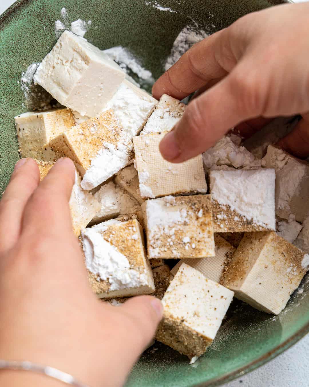 Coating the tofu with corn flour and spices