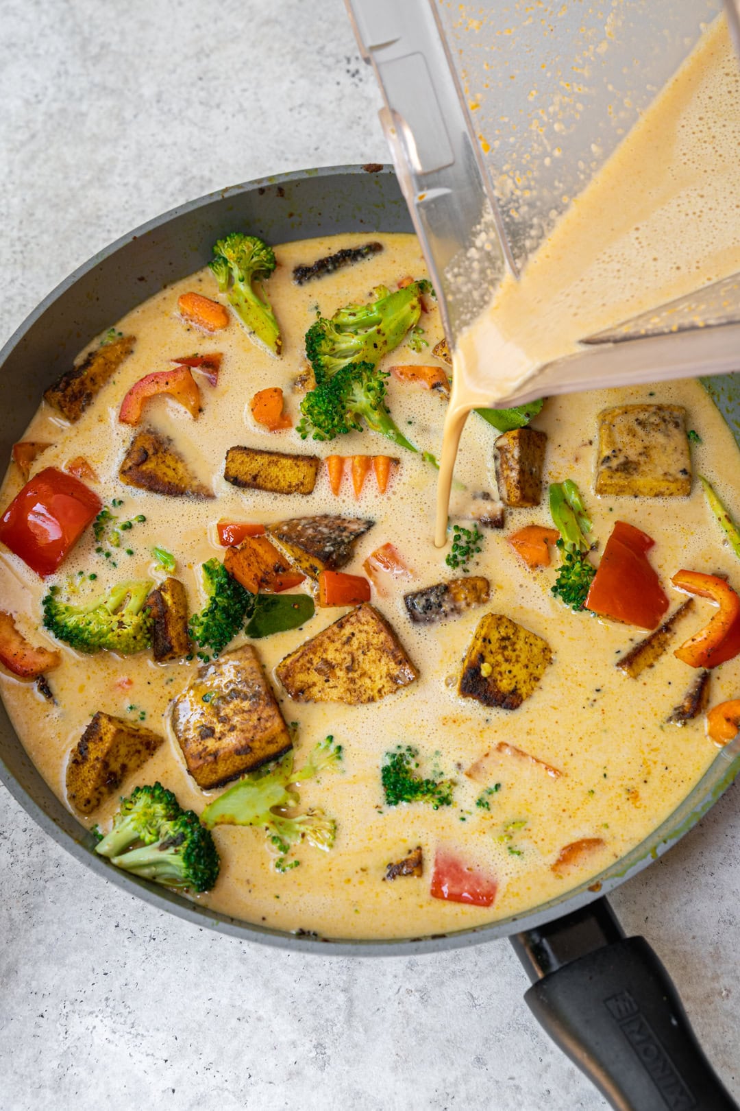 Adding peanut sauce to the pan
