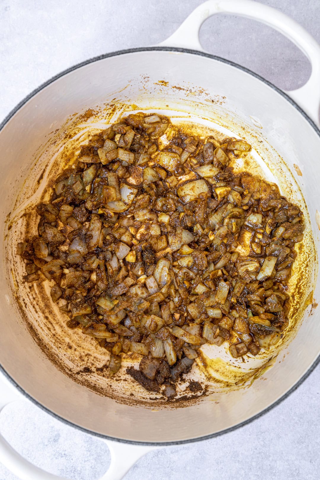 Stir frying onion, ginger, garlic, and spices.