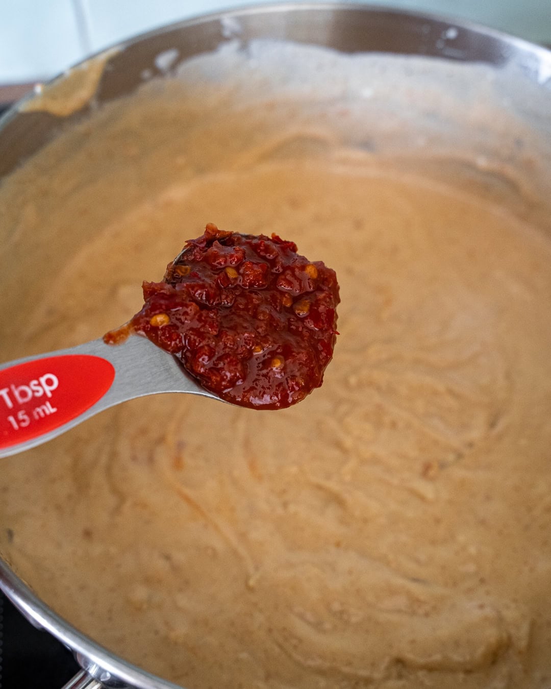 adding sambal or chili paste