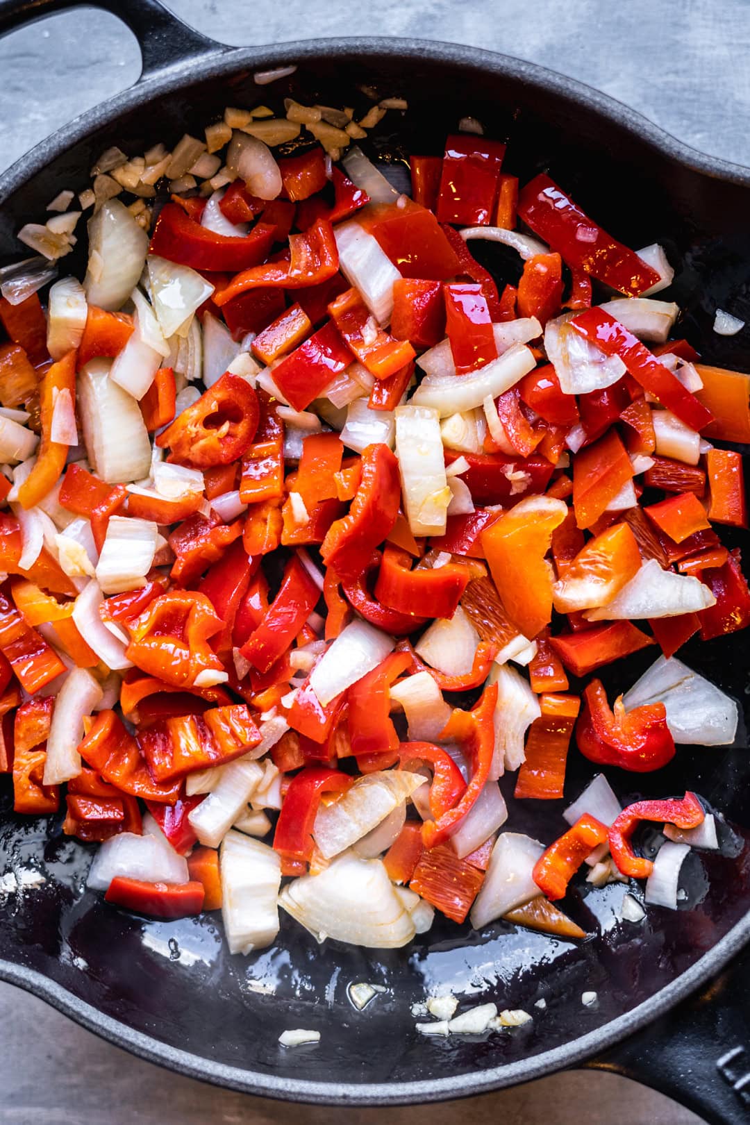 stir frying onion, garlic, and red bell pepper