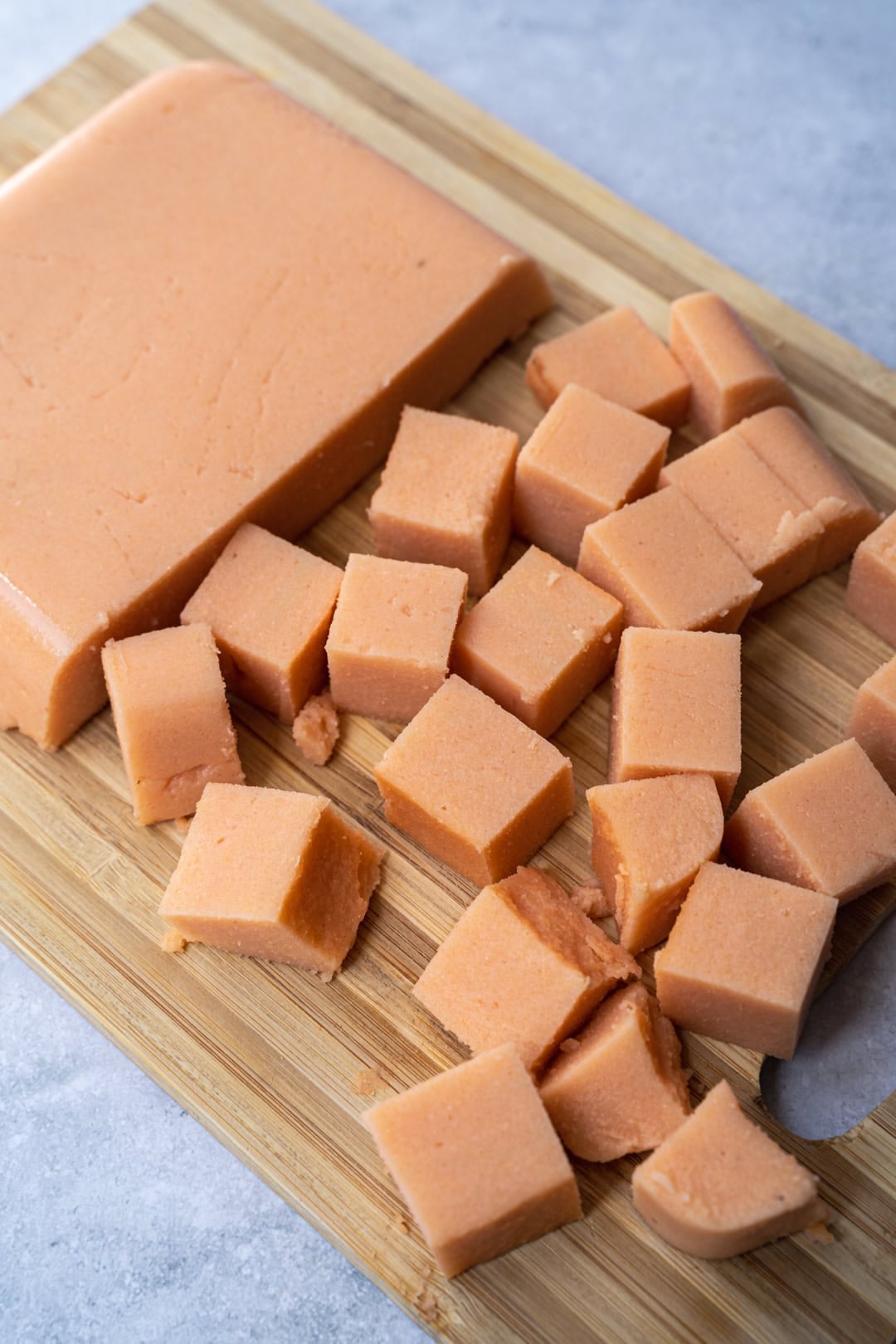 taking the red lentil tofu out of the container to cut and use.