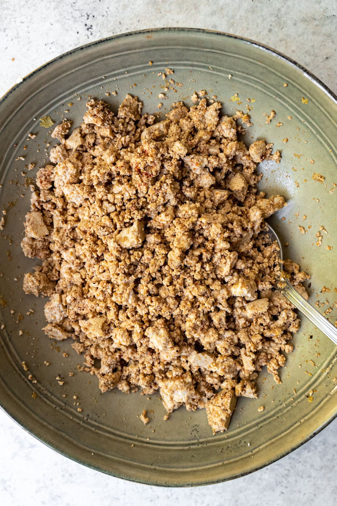 Combining tofu with spices and soy sauce for the bolognese sauce.