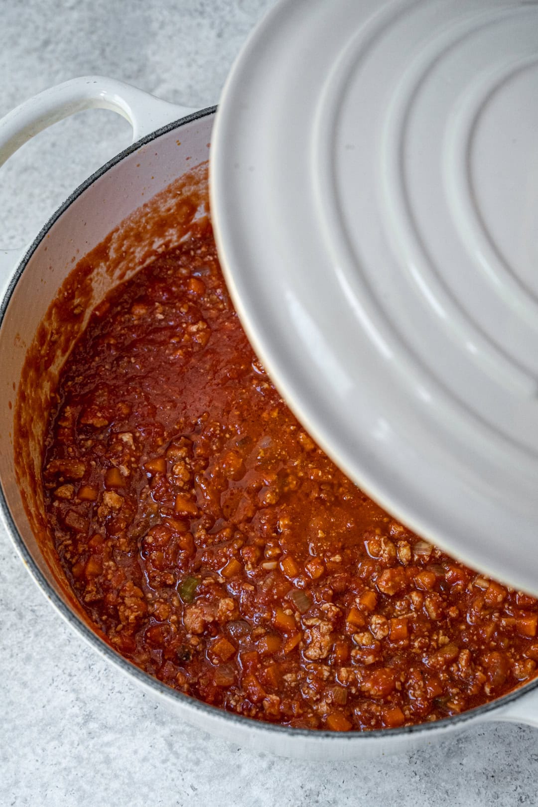 placing the lid on the bolognese pot