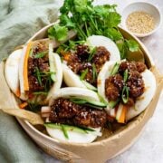 vegan bao buns served in bamboo steamer