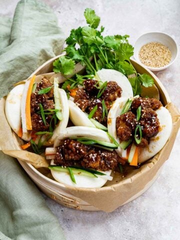vegan bao buns served in bamboo steamer