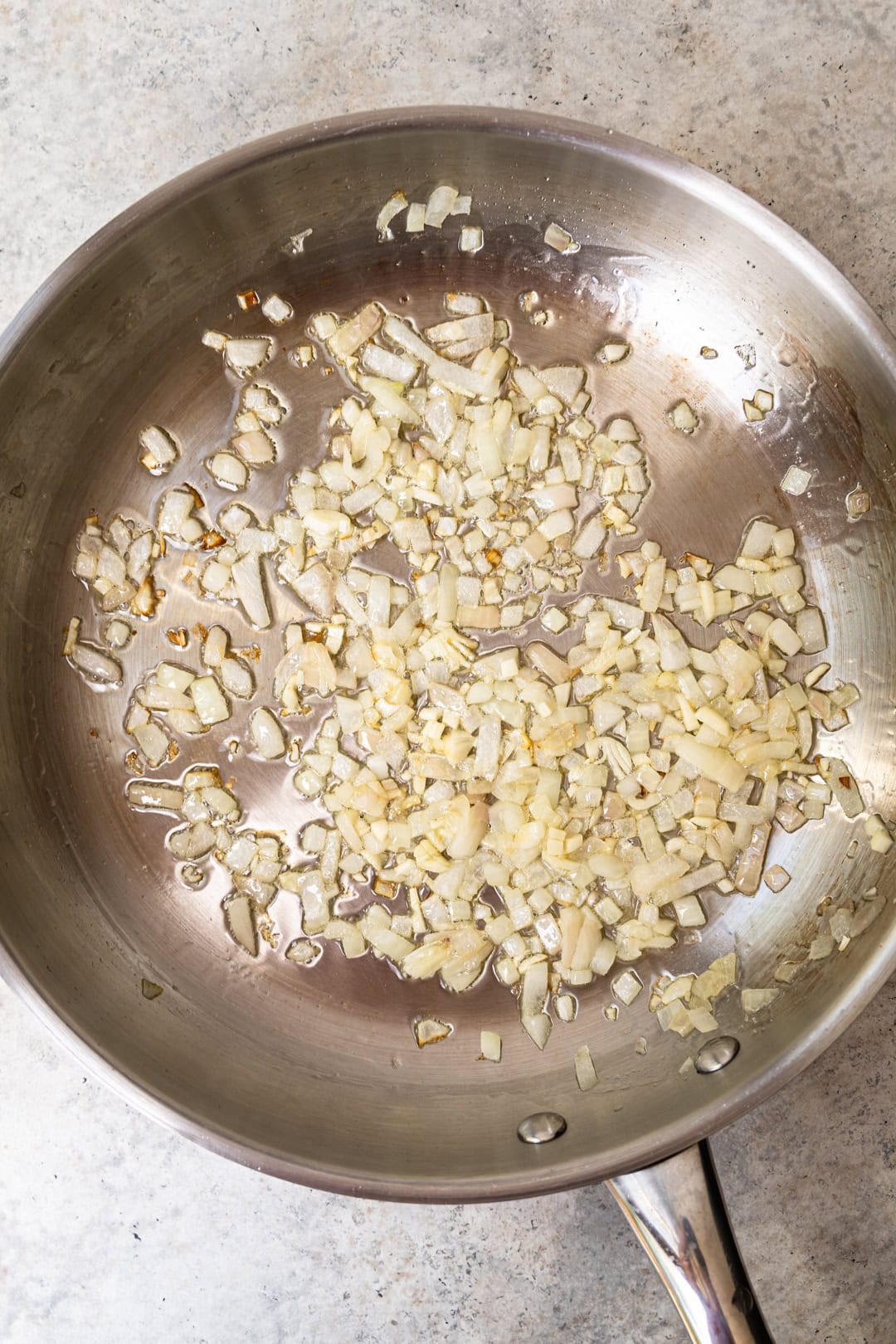 cooking onion and garlic using a frying pan