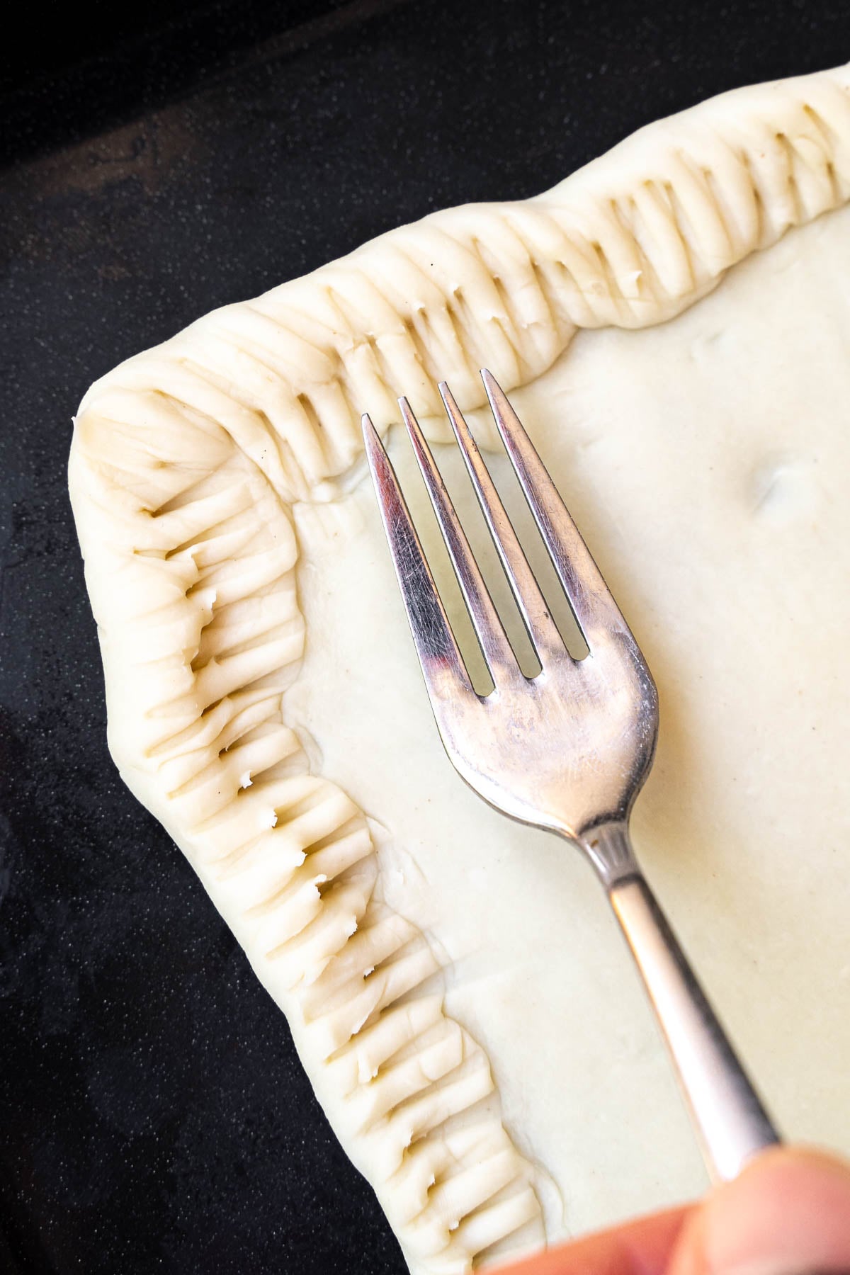 folding the edges to create a crust