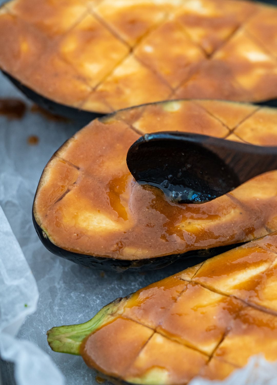 Adding miso dressing on the eggplants