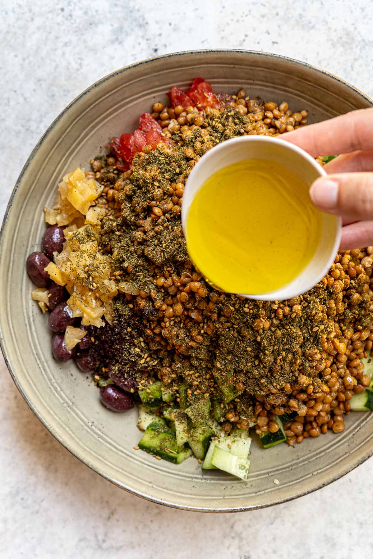 Adding olive oil and vinegar