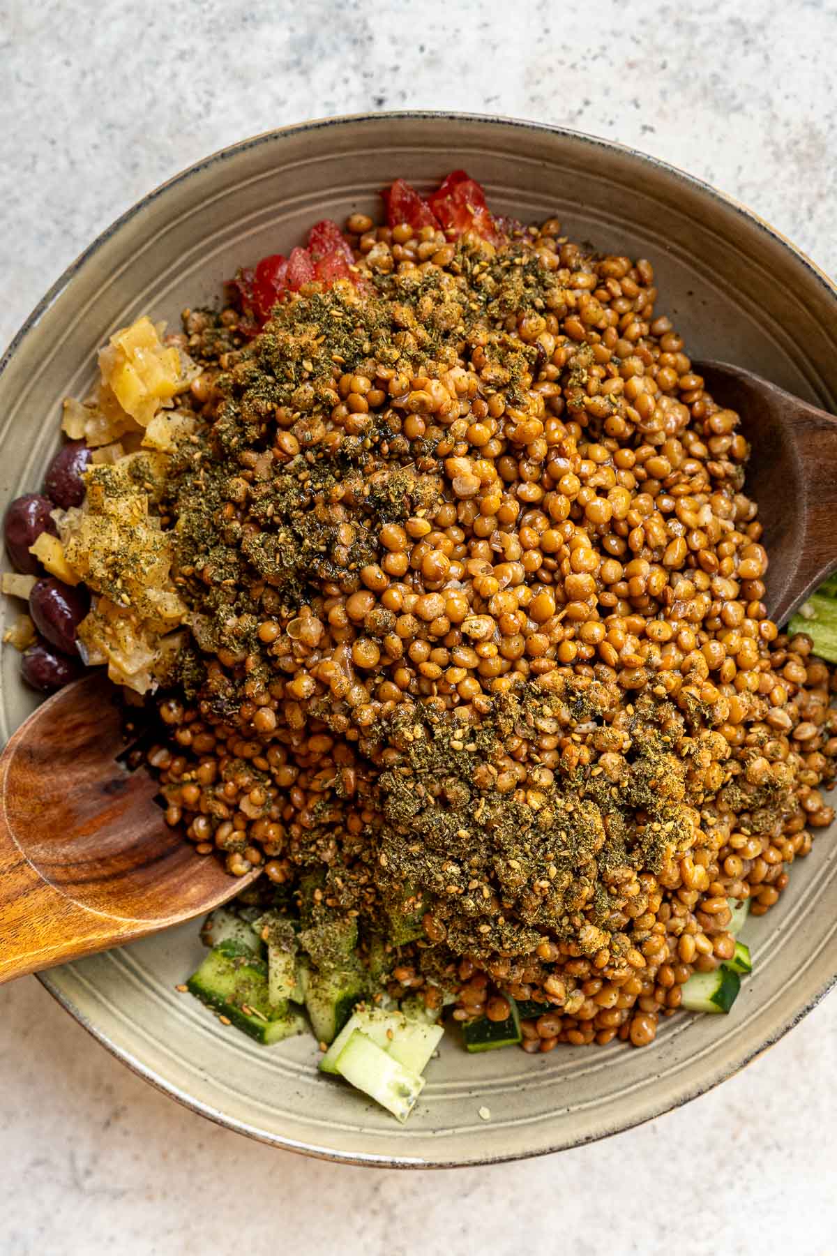 Adding zaatar and sumac to the lentil salad